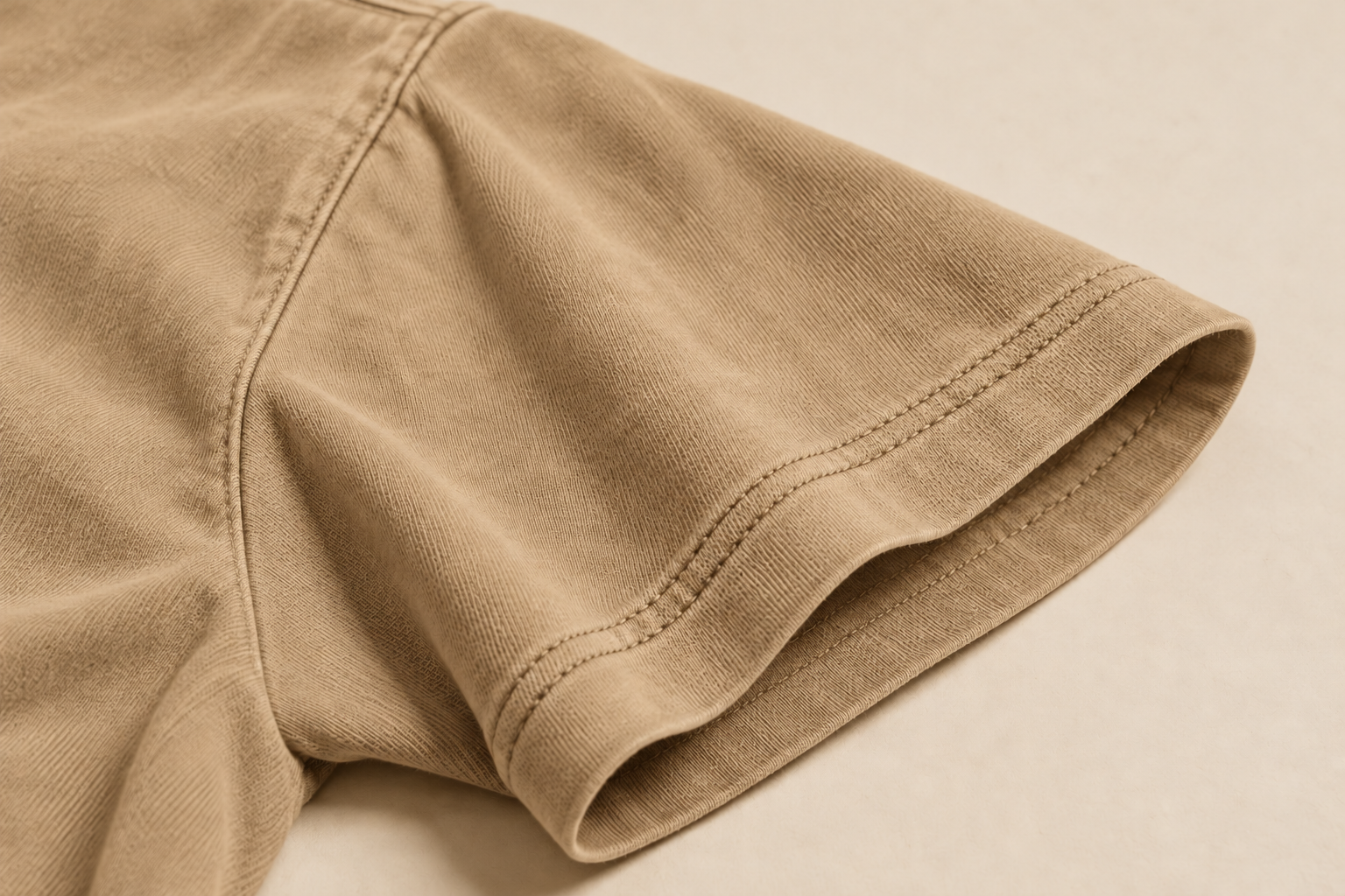 Design concept close-up of two parallel stitch rows at a sand tee’s sleeve hem