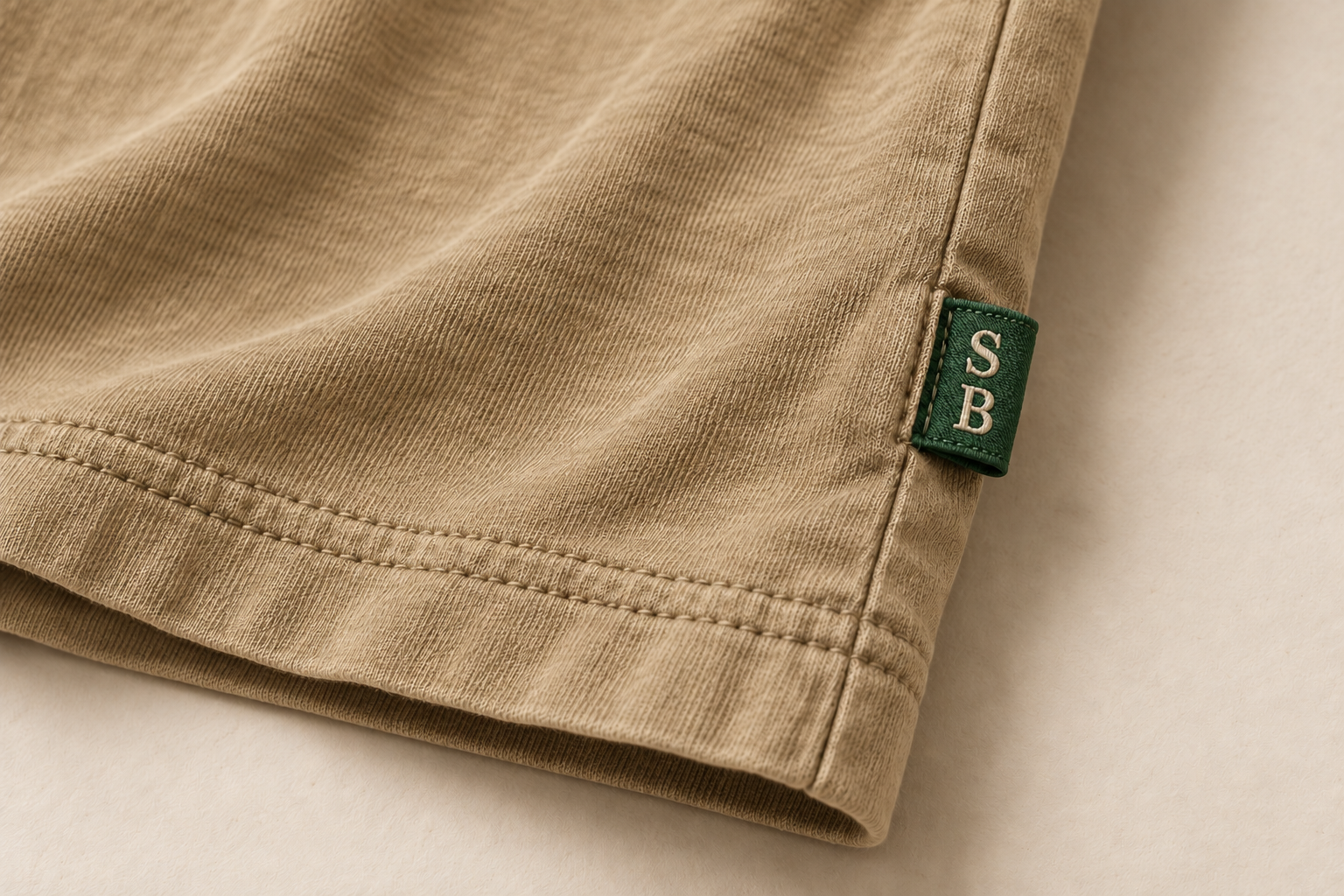 Design concept close-up of the brighter green SB woven side tag beside the double-stitched lower hem